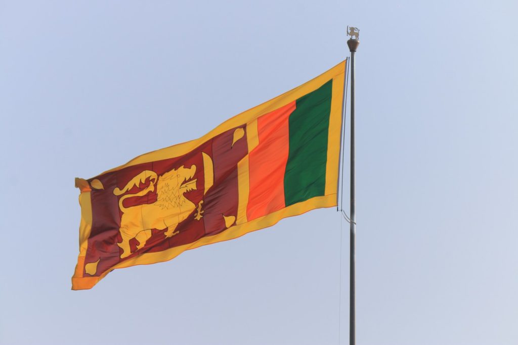 the flag of sri is flying high in the sky